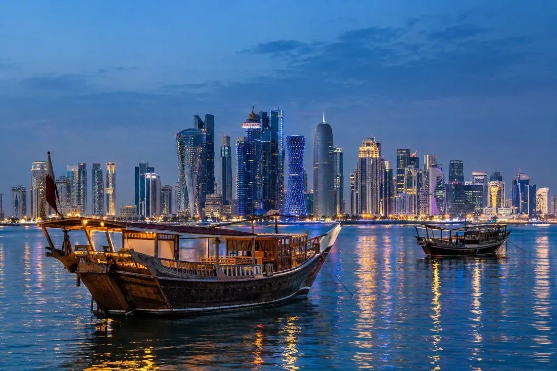 Doha West Bay skyline with traditional dhows